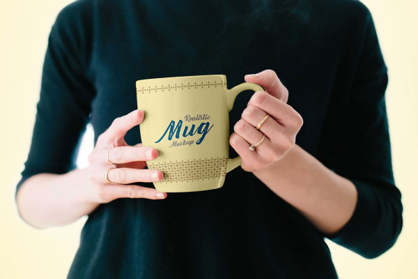 Mug in Female Hand Mockup