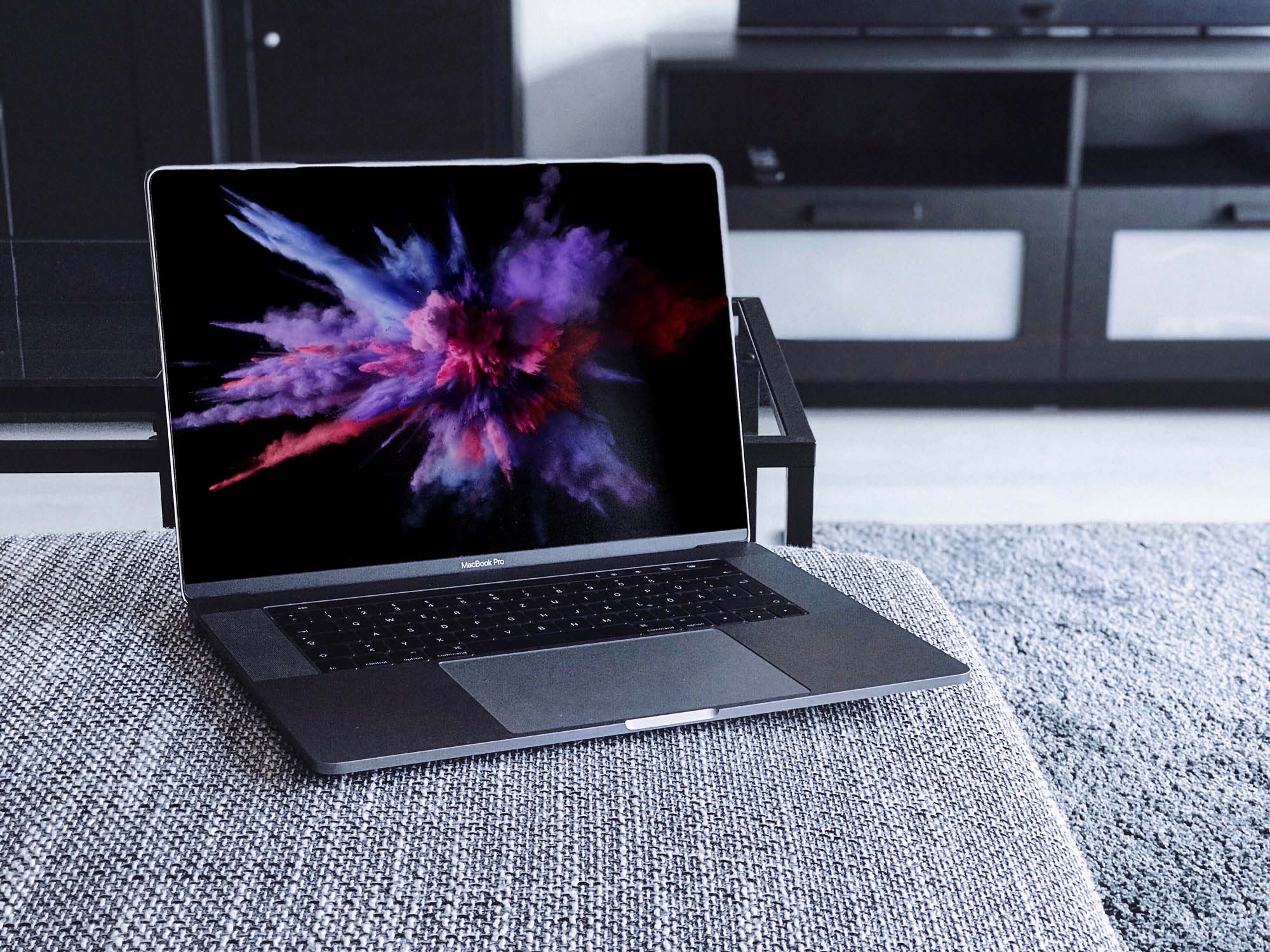 Download MacBook Pro on Couch PSD Mockup (Free) by Mckups